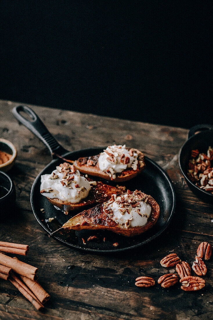 Baked pears with cinnamon, coconut cream and pecans