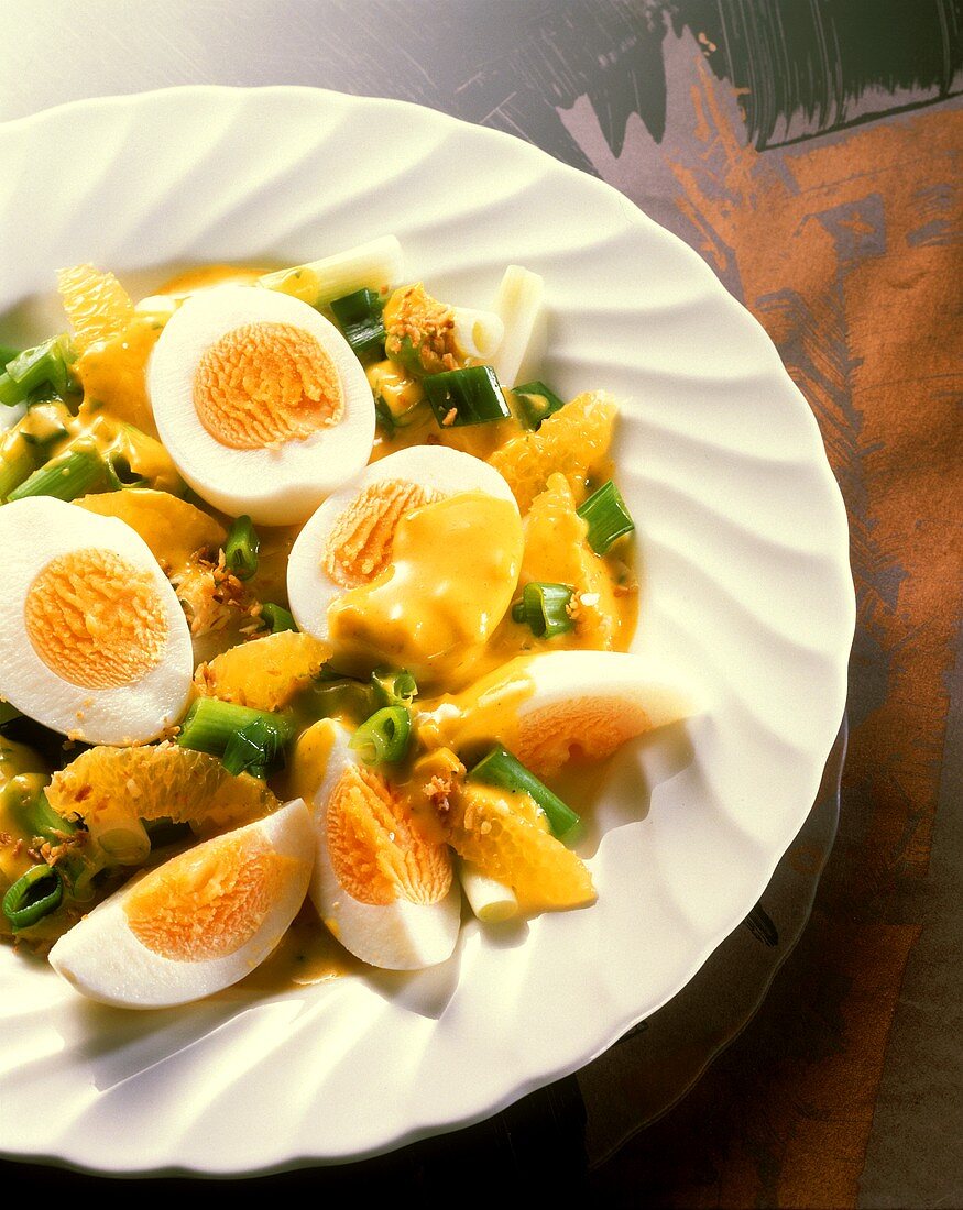 Boiled eggs with orange and spring onion ragout