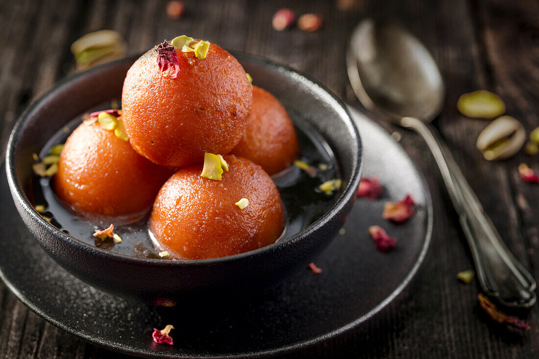 Gulab Jamun - Indian sweet made from milk, sugar, rose water and cardamom, in sugar syrup
