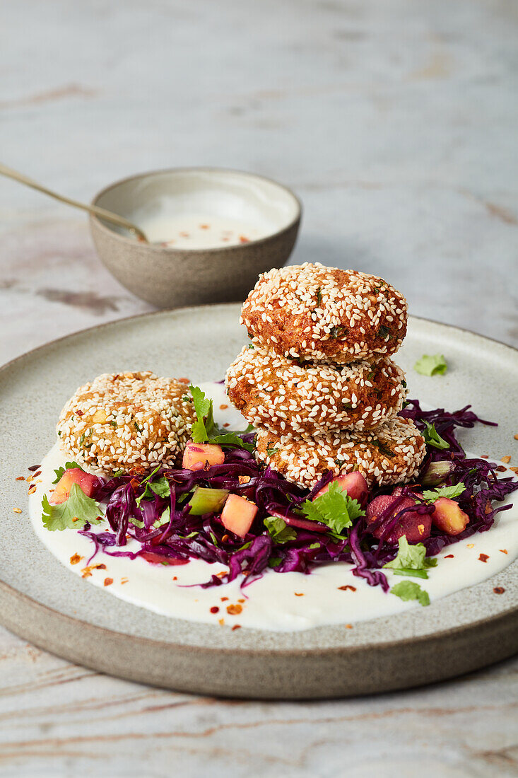 Vegan chickpea and sesame falafel on a mango and red cabbage salad