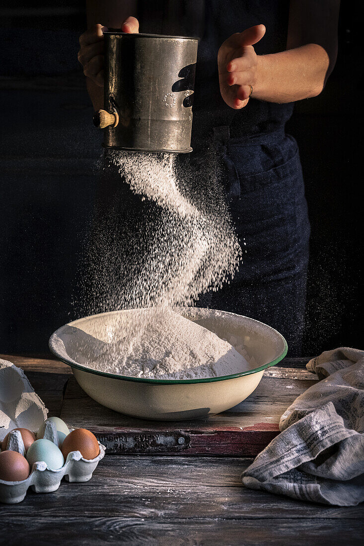 Woman sifting flour