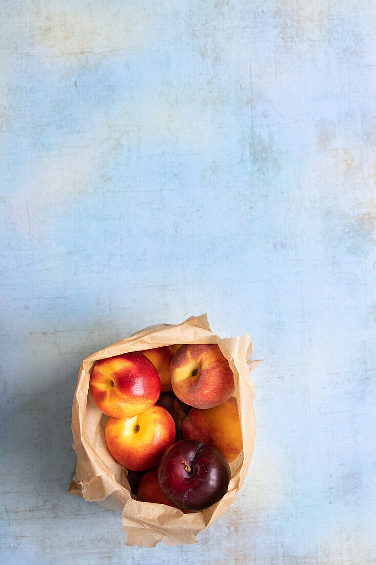 Nectarines and plums in a paper bag
