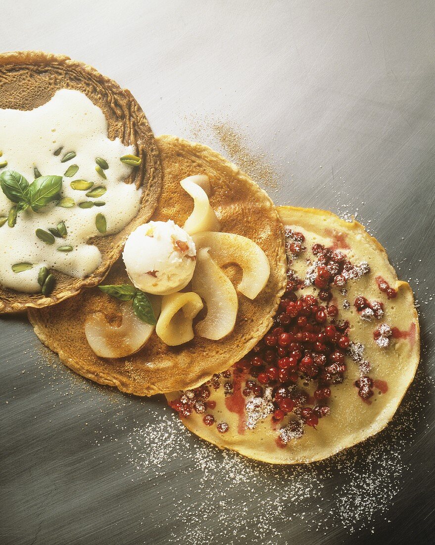 Pancakes with cranberries, ice cream, whipped pistachio sauce