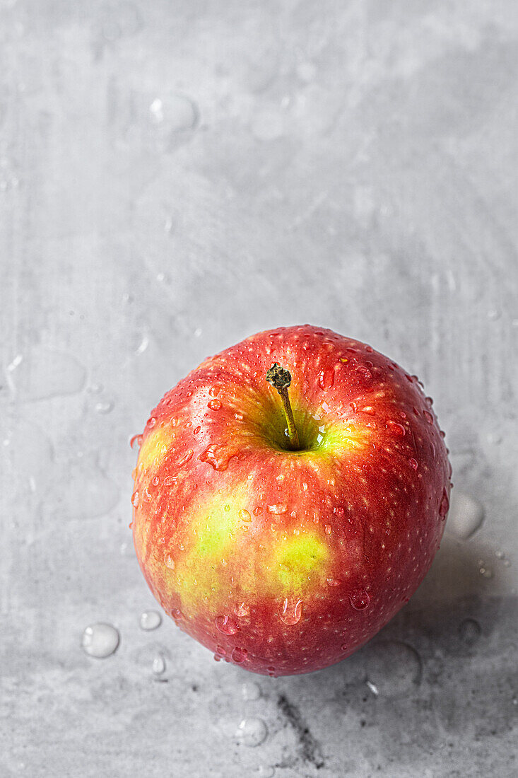 Red apple with water droplets