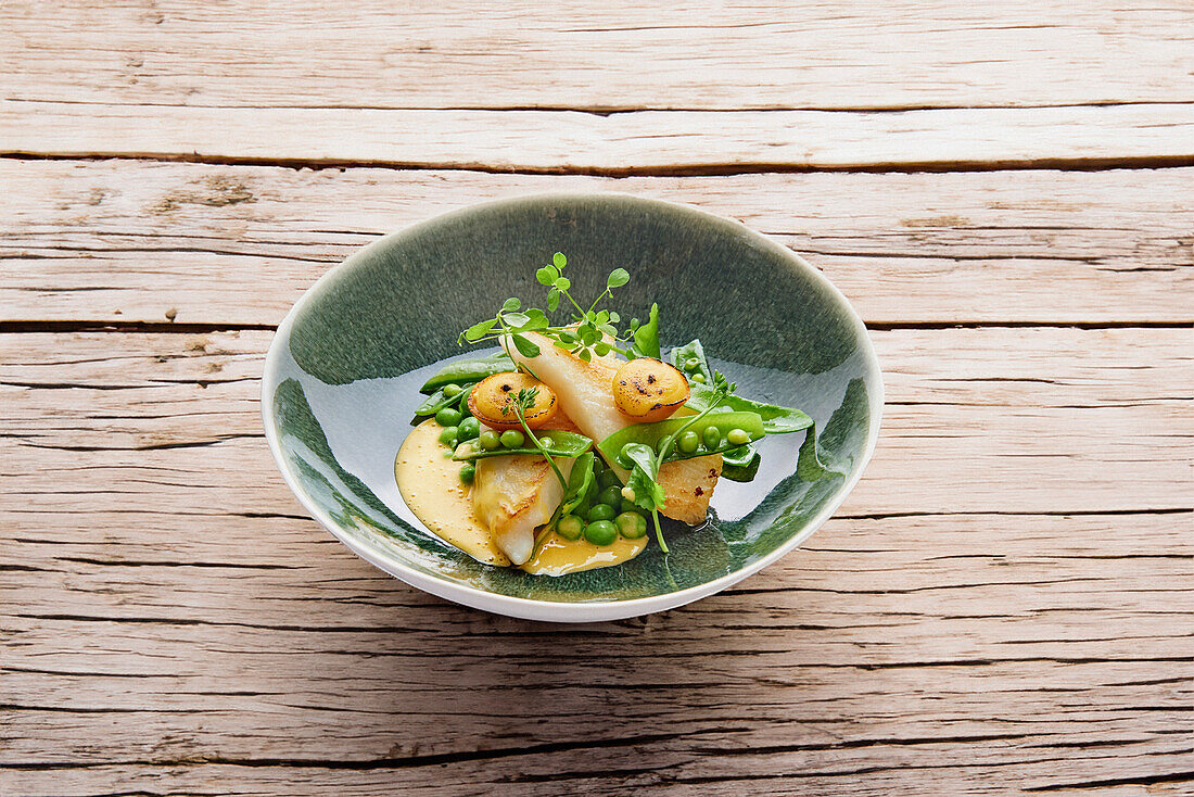 Fillet of St Peter's fish with peas and kumquat