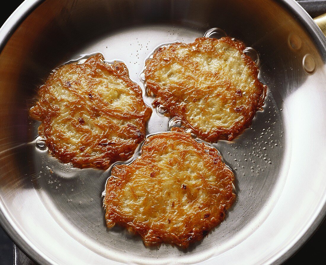 Frying potato rosti in a pan