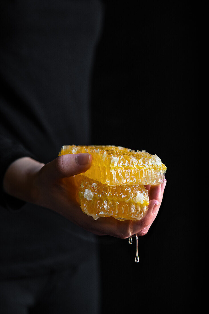 Woman holding dripping honeycomb