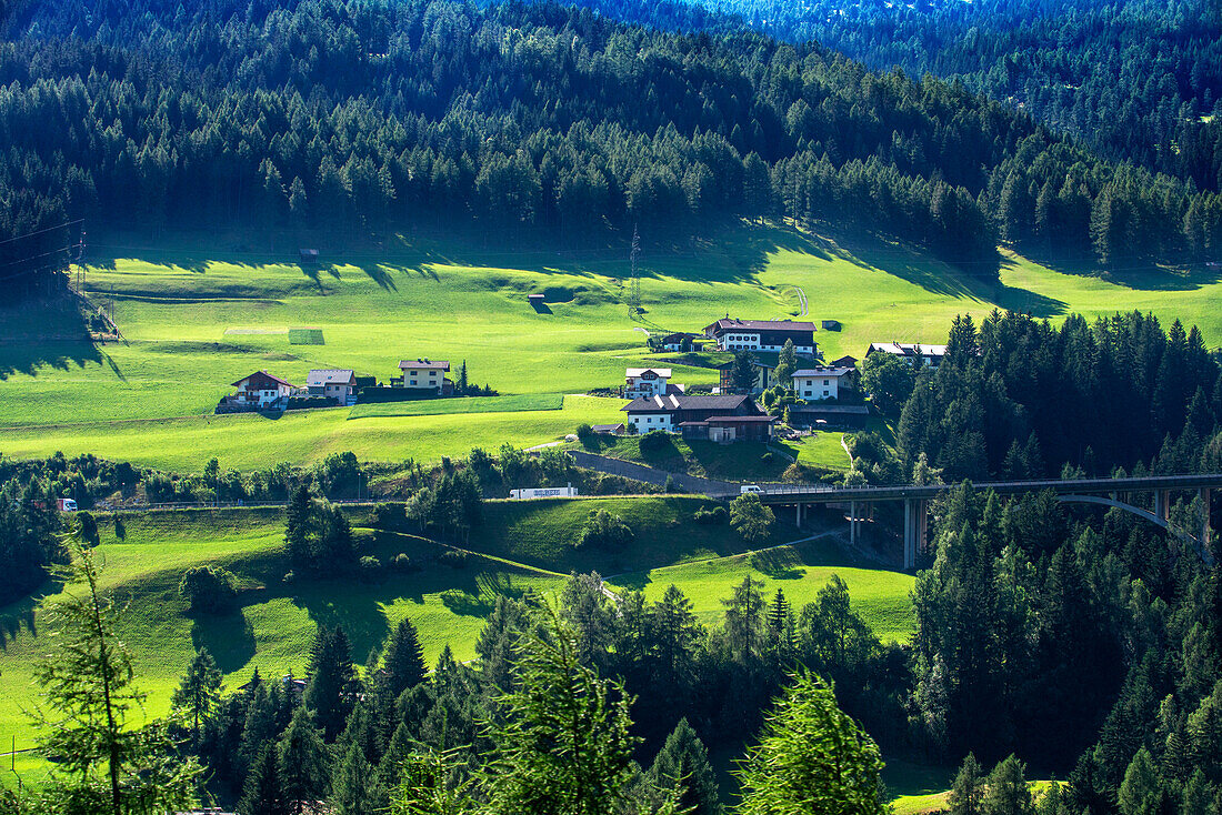 Train running along Renon plateau with Dolomites scenery. Belmond Venice Simplon Orient Express luxury train.