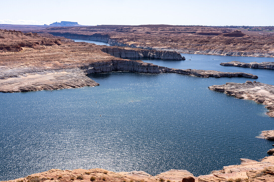 Boaters on Lake Powell in the Glen Canyon National Recreation Area, Arizona. The city of Page, Arizona, is behind.