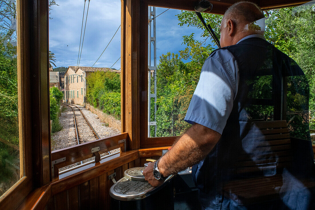 Driver of the vintage tram at the Soller village. The tram operates a 5kms service from the railway station in the Soller village to the Puerto de Soller, Soller Majorca, Balearic Islands, Spain, Mediterranean, Europe.