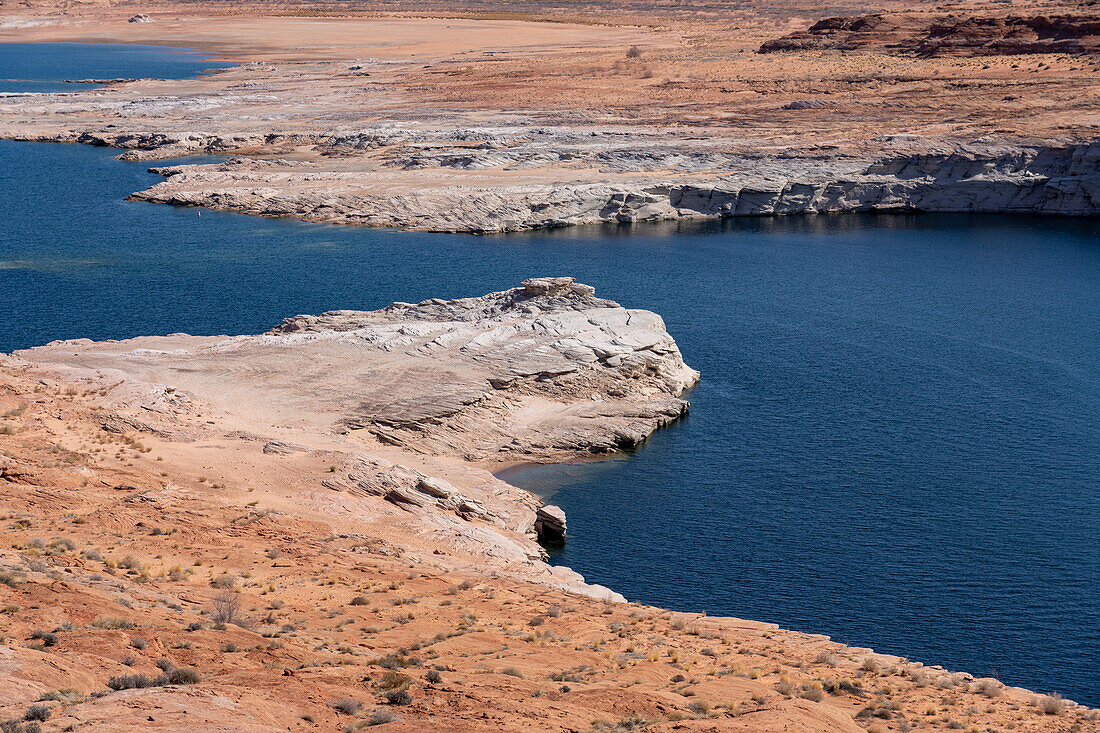 Bleached sandstone shows the former high water mark in Lake Powell. Glen Canyon National Recreation Area, Arizona. Due to drought, the lake was down 179 feet when this photo was taken.