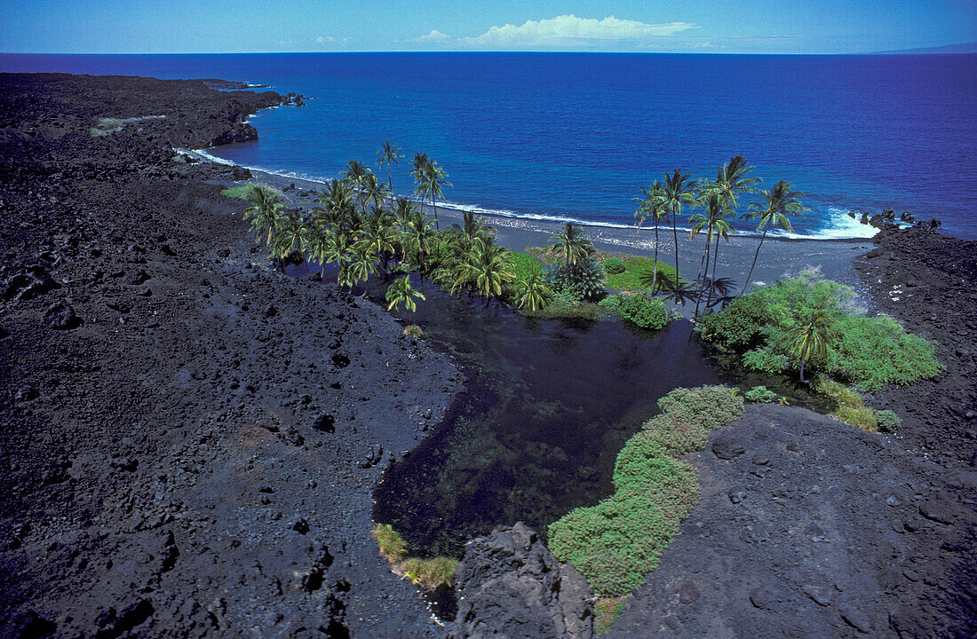 Luahinewai anchialine pond and black sand beach, North Kona, Island of Hawaii.