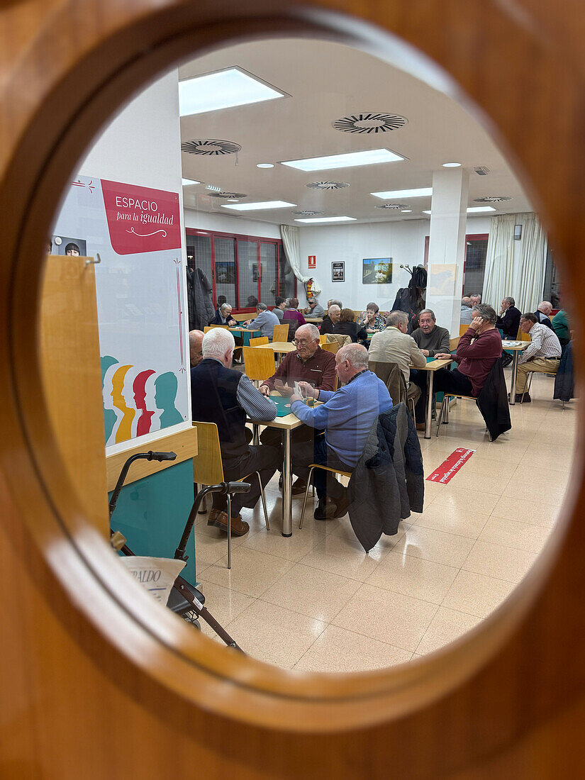 Elderly people playing cards at Isaac Valero Civic Center of Zaragoza, Spain