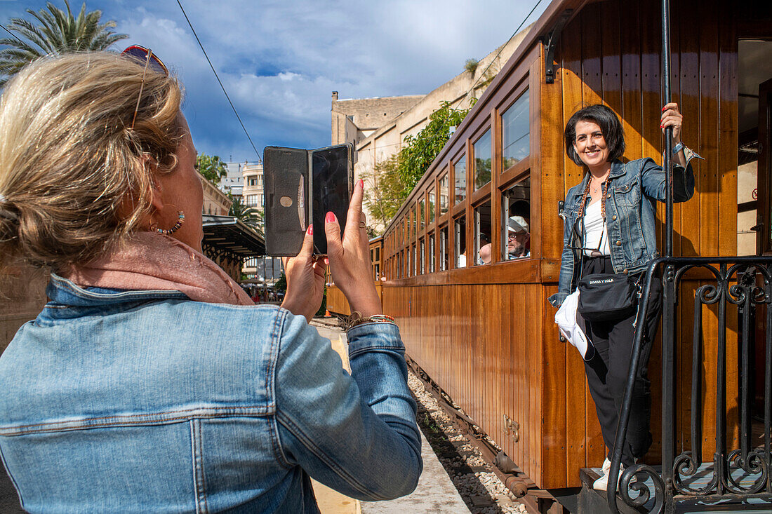Tourists in the tren de Soller train vintage historic train that connects Palma de Mallorca to Soller, Majorca, Balearic Islands, Spain, Mediterranean, Europe.