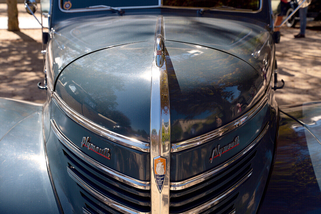 The front of a Plymouth classic car in a car festival in San Lorenzo de El Escorial, Madrid.