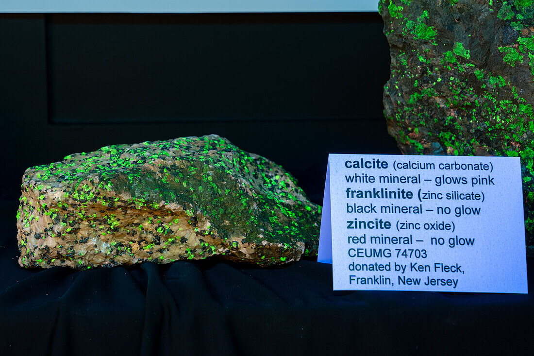 Franklinite, zincite & calcite minerals fluorescing under ultraviolet light. USU Eastern Prehistoric Museum, Price, Utah.