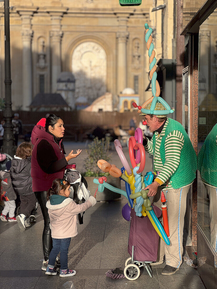Man selling shaped balloons in Calle Alfonso of Zaragoza, Spain