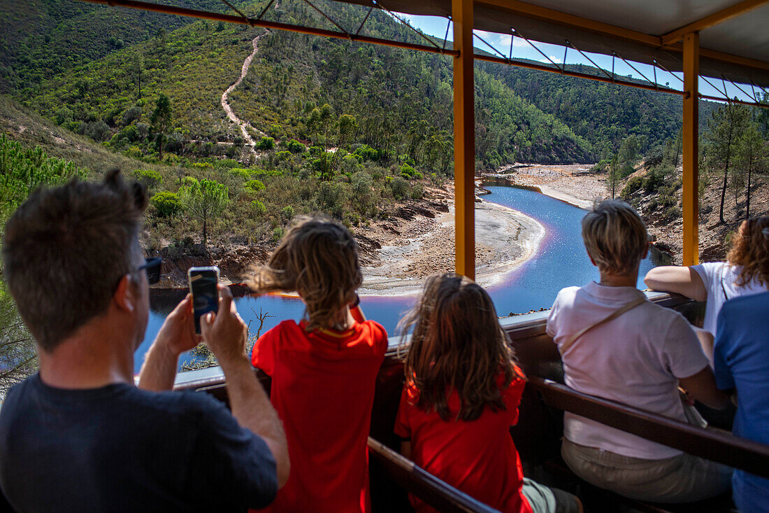 People inside the touristic train used for tourist trip through the RioTinto mining area, Huelva province, Spain.