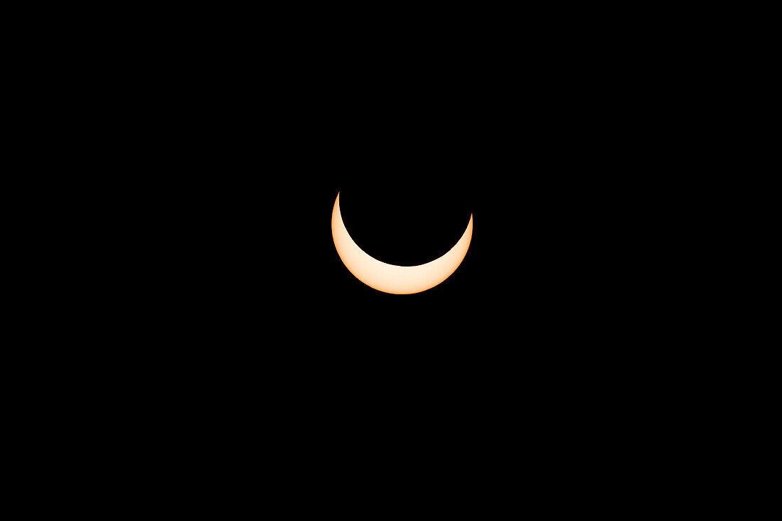 The moon moves in front of the sun during the annular solar eclipse on 14 November 2023. Utah, USA. 15 minutes before annularity.