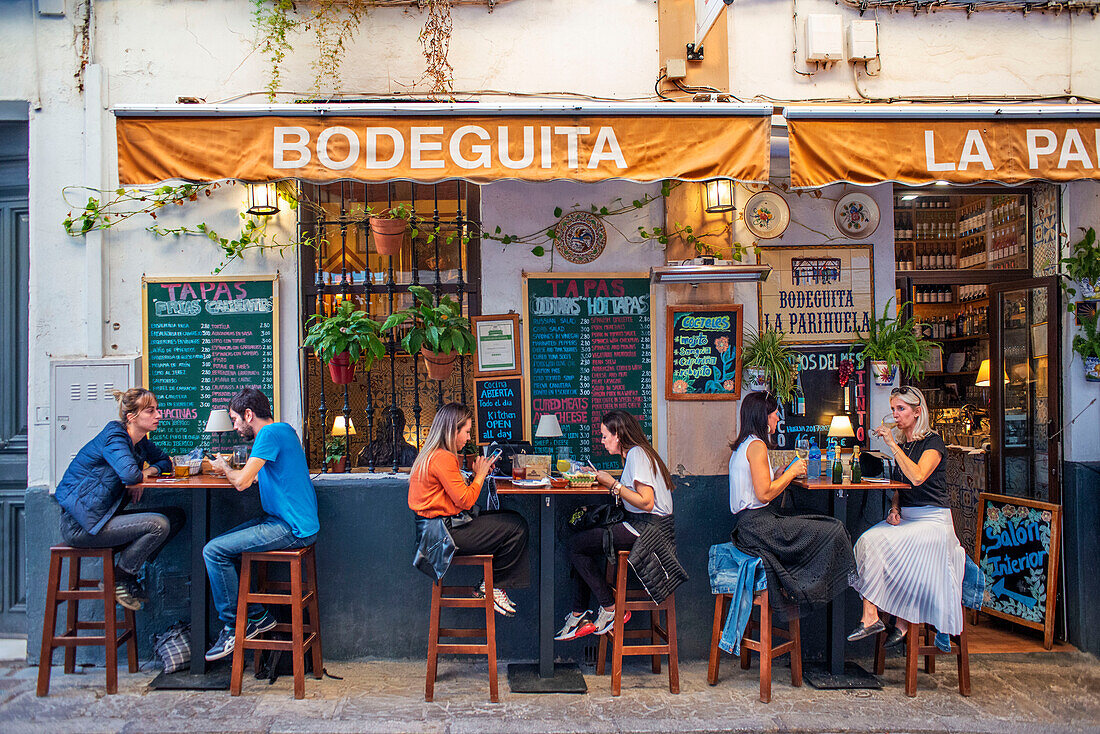 Locals enjoying food in Bodeguita La Parihuela tapas bar in Santa Cruz district Seville Antalusia Spain