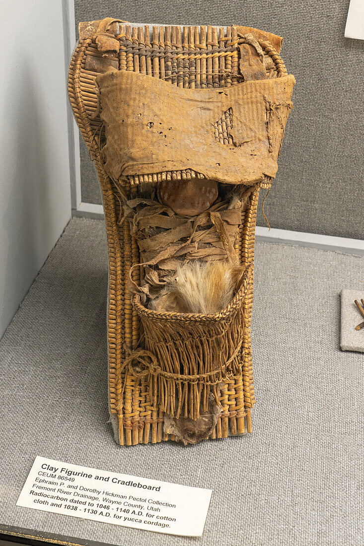 A Fremont culture cradleboard or papoose board with a clay figurine in the USU Eastern Prehistoric Museum in Price, Utah.