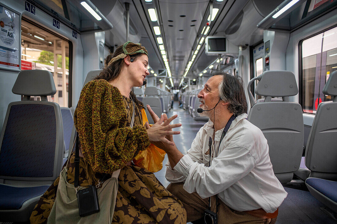 Actors performing Don Quixote de la Mancha and Dulcinea del Toboso inside the Cervantes Train between Atocha train Station and Alcala de Henares, Madrid Spain