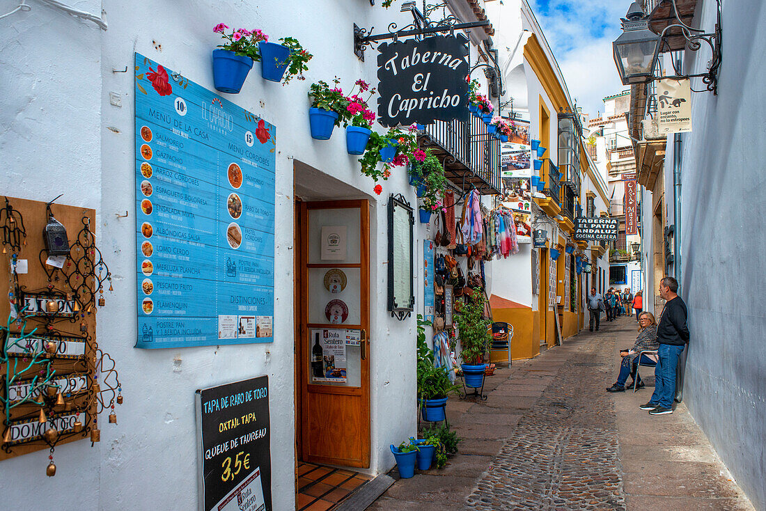 Shops bars and restaurants outside the La Mezquita Cathedral Mosque in the historic old town La Juderia, Cordoba, Andalucia, Spain.