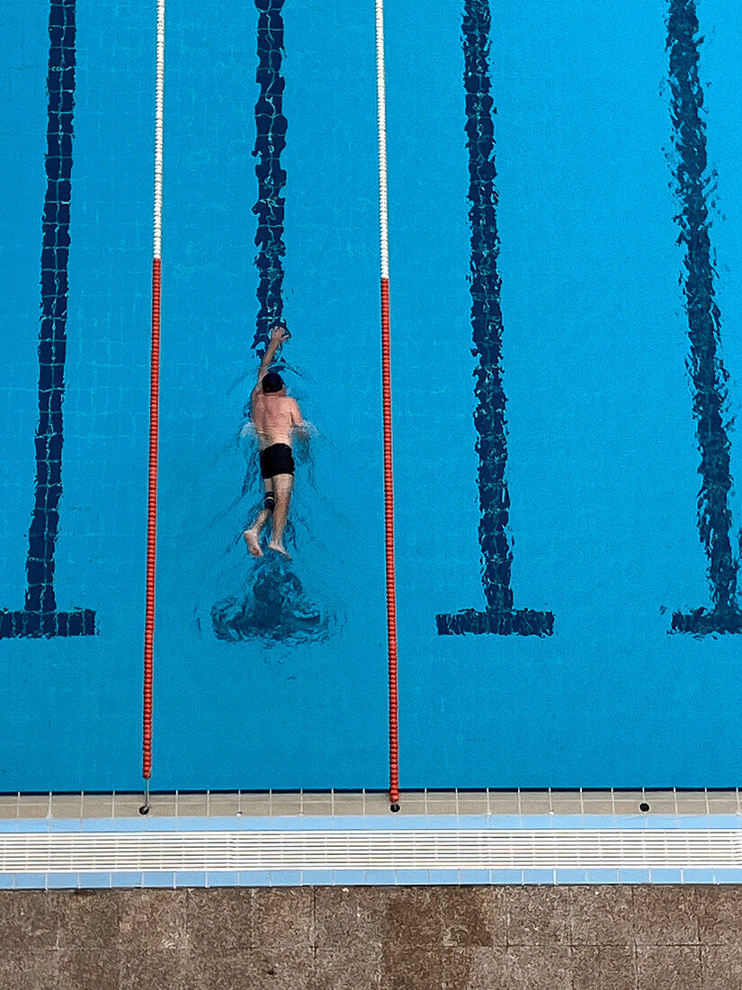 Aerial photo of a man swimming in an outdoors pool