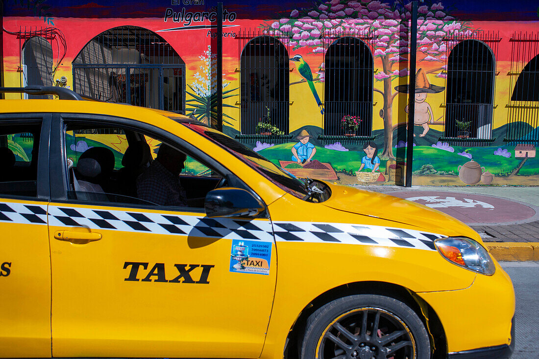 San Salvador city center. Taxis and pupuseria El Gran Pulgarcito in Santa Tecla neighborhood. El Salvador, Central America.