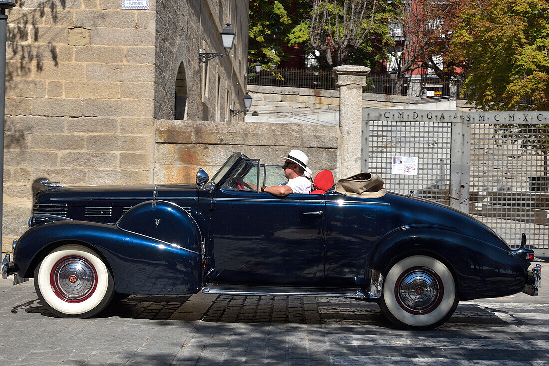 A Cadillac classic car on the road in a car festival in San Lorenzo de El Escorial, Madrid.