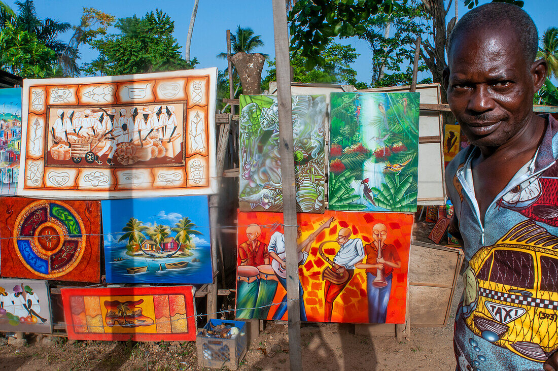 Local painter selling souvenirs in the Las Terrenas city center Samana, Dominican Republic, Carribean, America.