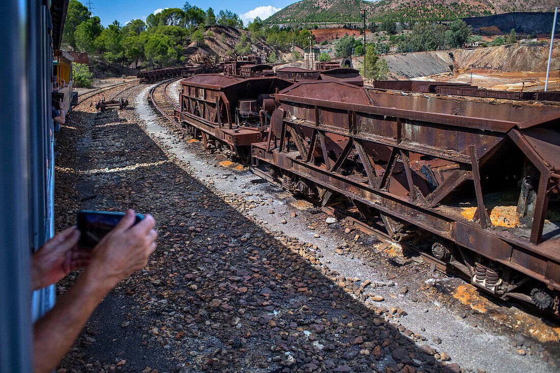 Old abandoned steam trains seen from the touristic train used for tourist trip through the RioTinto mining area, Huelva province, Spain.