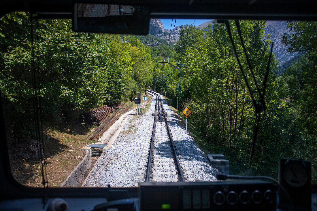 Views from the window. Cogwheel railway Cremallera de Núria train in the Vall de Núria valley, Pyrenees, northern Catalonia, Spain, Europe.