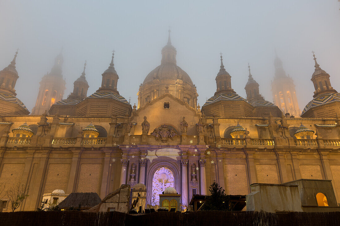 Cathedral-Basilica of Our Lady of the Pillar covered in fog as temperatures go down in Zaragoza, Spain