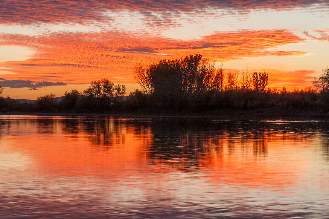 Colorful sunset skies reflected in the Green River near Jensen, Utah.