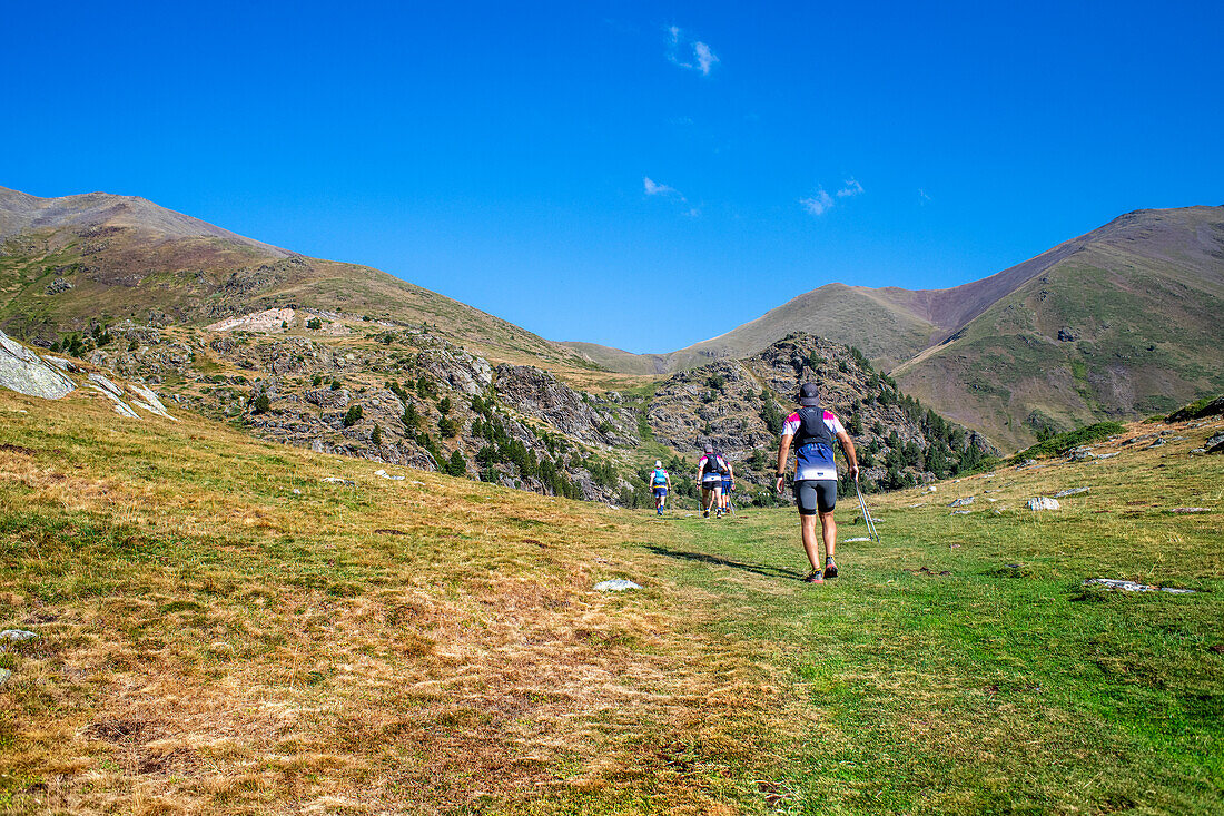Rear view of people walking to the Summit of the Puigmal mountain, Catalan, Pyrenees, Spain