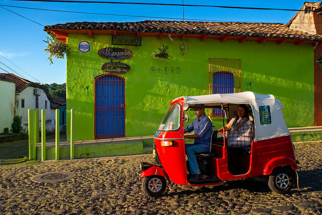 Colorful red tuktuk and architecture of Suchitoto colonial village. Suchitoto, Cuscatlan, El Salvador Central America