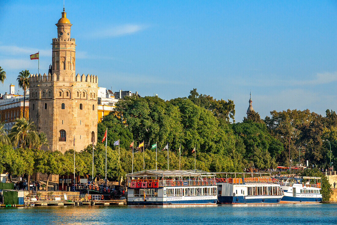Guadalquivir river and The Torre del Oro what translates to Tower of Gold - historical landmark from XIII century in Seville, Andalusia, Spain