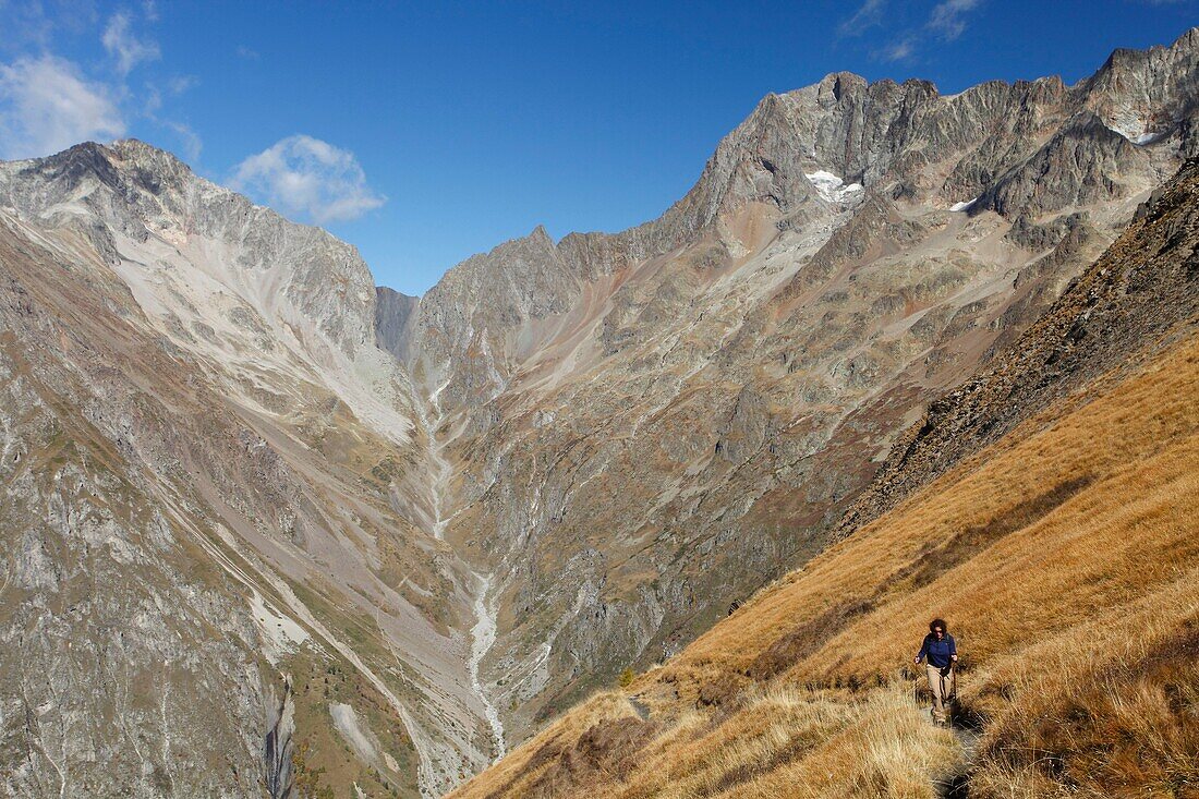France, Isere, Valjouffrey, Ecrins National Park, Haut Beranger valley, Female hiker walking toward Cote Belle pass