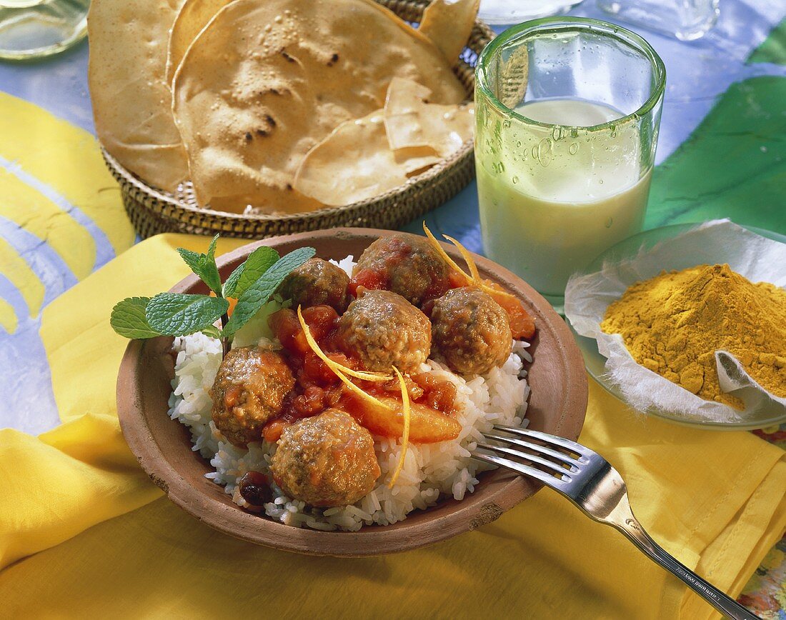 Indische Fleischbällchen mit Tomaten-Orangen-Sauce auf Reis