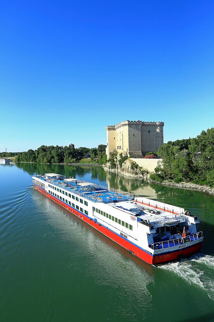France, Bouches du Rhone, Tarascon, medieval castle of King Rene (XV), historical monument and cruise ship on the Rhone