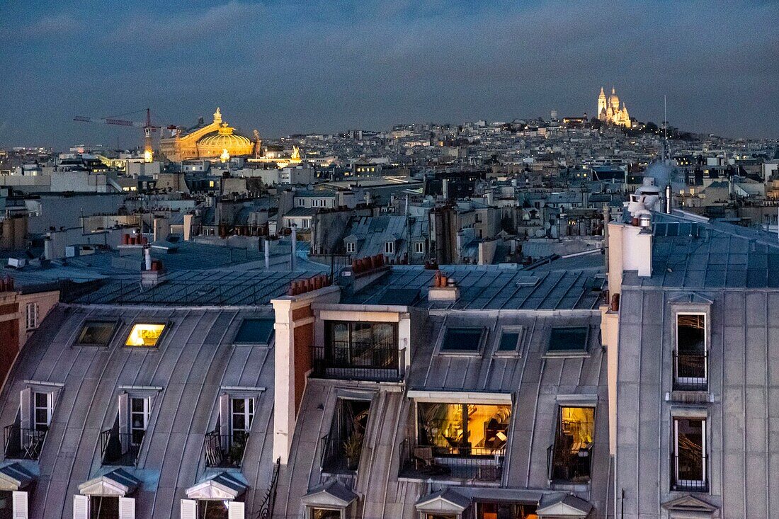 France, Paris, Zinc roofs of rue de Rivoli, Opera Garnier and Montmarte in the background