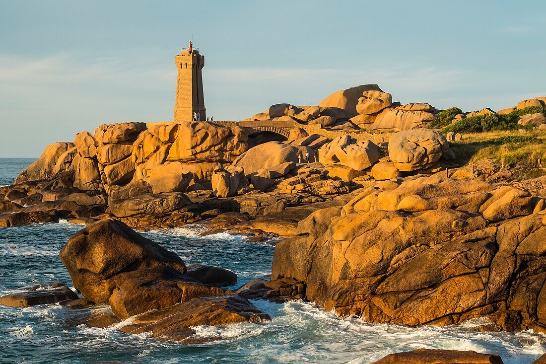 France, Cotes d'Armor, Ploumanach, Perros-Guirec, Pink granite coast, the lighthouse of Ploumanac'h or lighthouse of Mean Ruz at sunset on the footpath of Customs or GR Grande 34 hiking trail