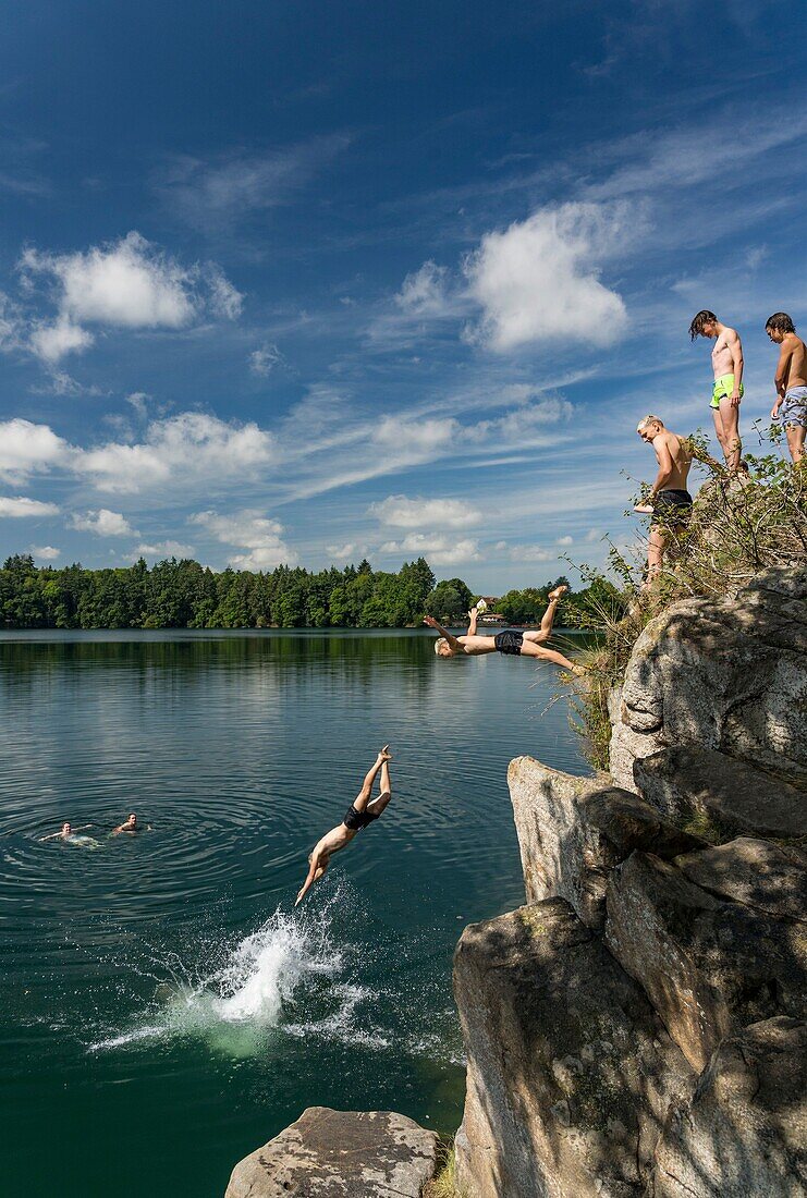 France, Puy de Dome, Charbonnieres les Vieilles, Gour de Tazenat, Maar volcano type, diving from the top of the rock