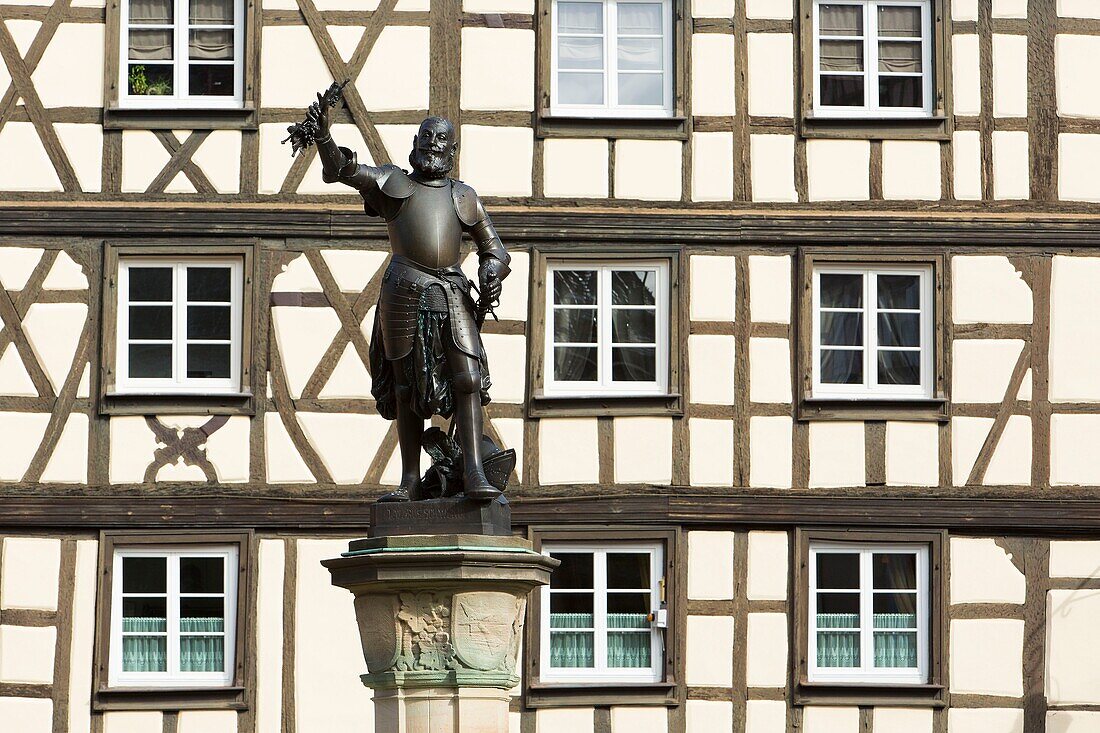 France, Haut Rhin, Route des Vins d'Alsace, Colmar, fountain by Frederic Auguste Bartholdi dedicated to Lazare de Schwendi and facade of a half timbered house on the former custom office square (Koifhus)
