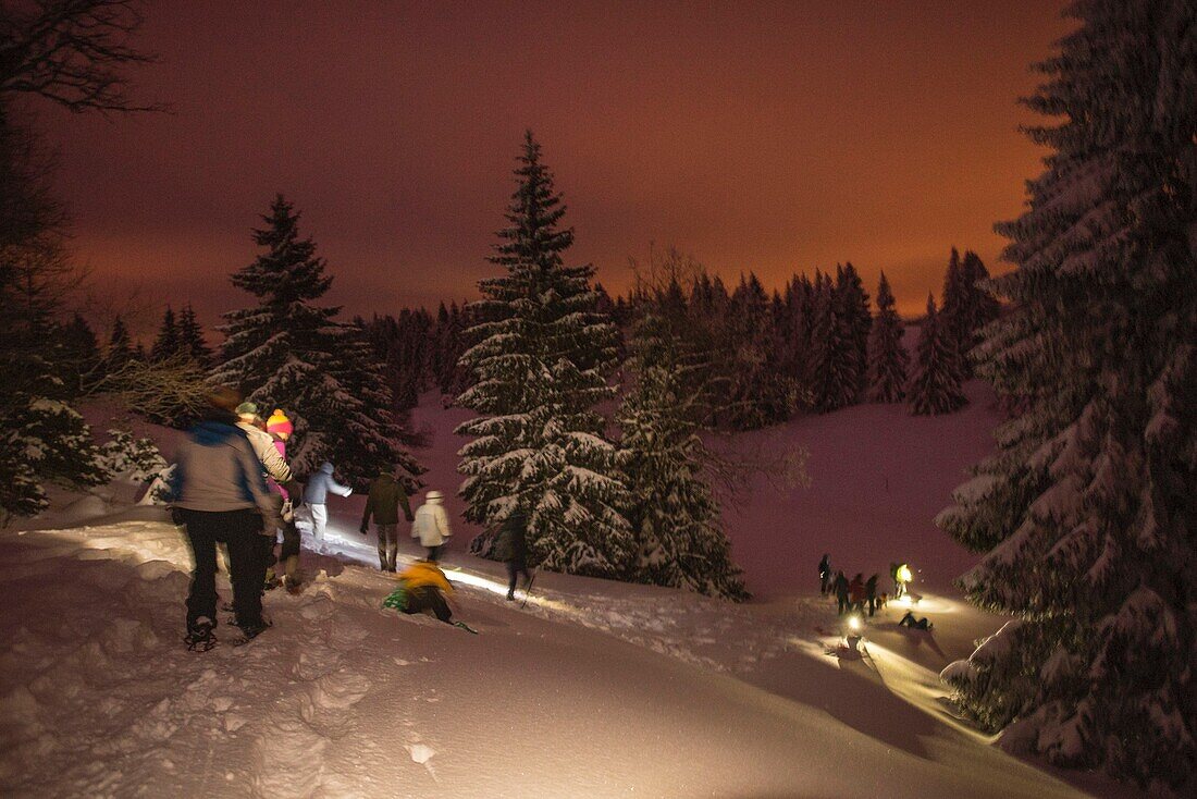 France, Jura, GTJ great crossing of the Jura on snowshoes, snowshoe outing accompanied by Lucas Humbert at night from the cottage of the new life in Molunes