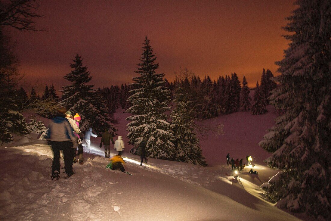 Frankreich, Jura, GTJ große Überquerung des Jura auf Schneeschuhen, Schneeschuhwanderung in Begleitung von Lucas Humbert bei Nacht von der Hütte des neuen Lebens in Molunes