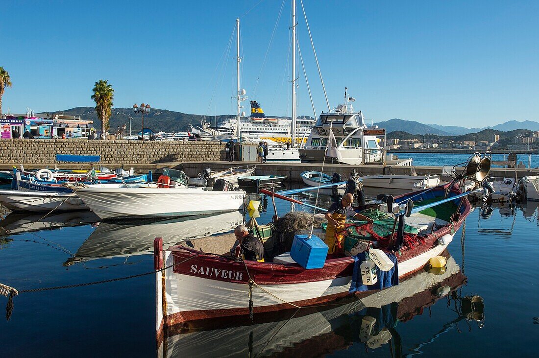 France, Corse du Sud, Ajaccio, fishermen at work on their wooden boat in the port Tino Rossi
