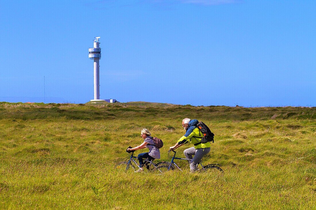 France, Finistere, Ponant Islands, Armorica Regional Nature Park, Iroise Sea, Ouessant Island, Biosphere Reserve (UNESCO), Bicycle Walkers in front of the Stiff Radar Tower