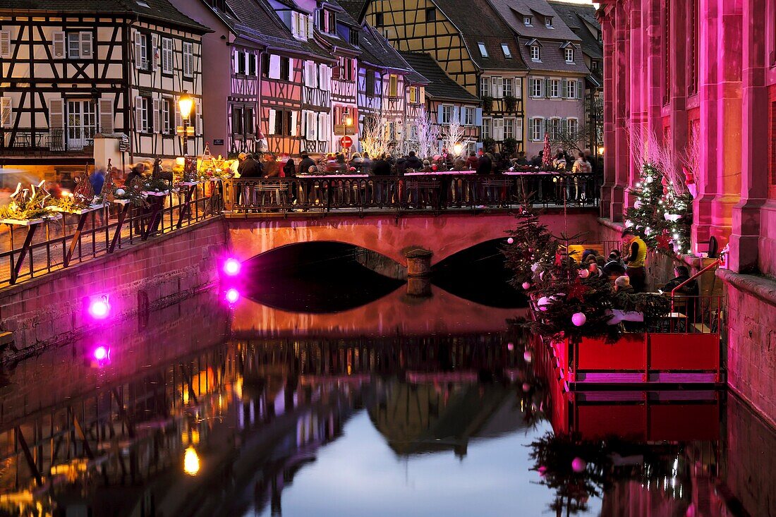 France, Haut Rhin, Colmar, Petite Venise, Quai de la Poissonnerie, bidge over La Lauch river, timbered houses, covered market hall dated 1865, illuminations during the Christmas market